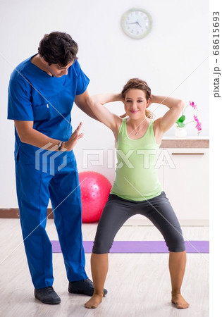 Pregnant woman doing physical exercies with instructor Pregnant woman doing physical exercies with instructor 68615693