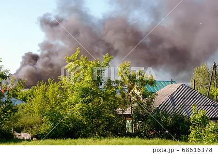 Fire everywhere and smoke in a residential area at night. Dangerous fire.Window of a house on fire. selective focus Fire everywhere and smoke in a residential area at night. Dangerous fire.Window of a house on fire. selective focus 68616378