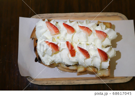 toast with cream and strawberry topping 68617045