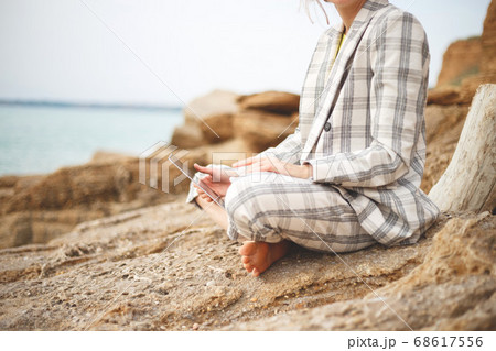 girl with a laptop by the sea. remote work concept girl with a laptop by the sea. remote work concept 68617556