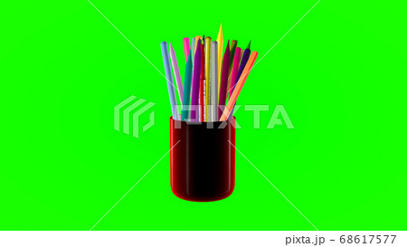 Rotating glass with colored pencils on a green Rotating glass with colored pencils on a green 68617577