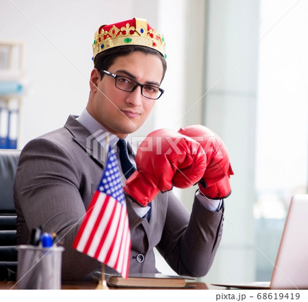 Businessman with American flag in office Businessman with American flag in office 68619419