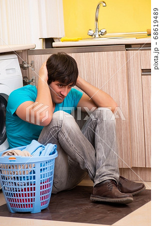 Young husband man doing laundry at home Young husband man doing laundry at home 68619489