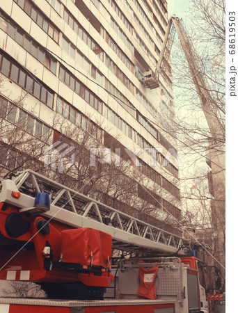 Fire with black smoke in multistory apartment building. Toned Fire with black smoke in multistory apartment building. Toned 68619503