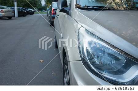 A car parked in the courtyard of a residential building. 68619563