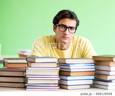 Student with too many books to read before exam Student with too many books to read before exam 68619998