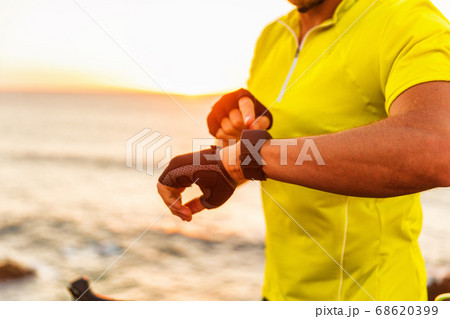 Sport smartwatch fitness tracking app triathlon man biking analyzing data from competition race. Health and fitness heart rate monitor 68620399