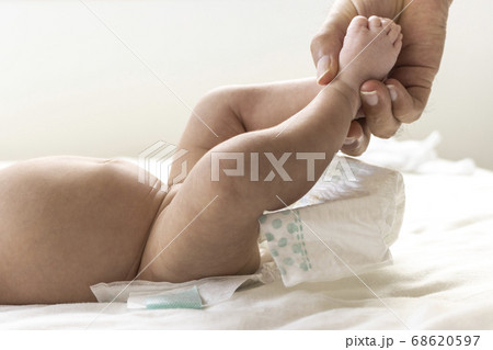 赤ちゃんの紙おむつを交換している男性の手 赤ちゃんの紙おむつを交換している男性の手 68620597