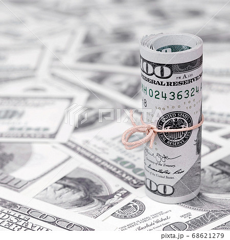 US dollars rolled up and tightened with band lies 68621279