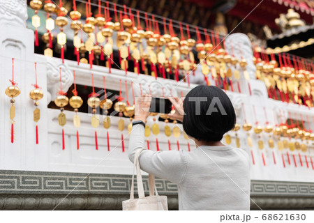 woman take a picture at the golden bells woman take a picture at the golden bells 68621630