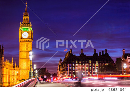 London Big Ben and westminster street crowd and traffic night life. Long exposure of speed motion people walking and cars driving on bridge. Europe travel destination 68624044