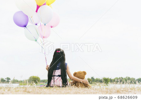 Happy Child hug teddy bear hold air balloon in Happy Child hug teddy bear hold air balloon in 68626609