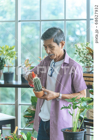 Senior Asian retired man is spraying water on 68627932