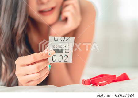 No bra Woman is preparing her condom for 68627934