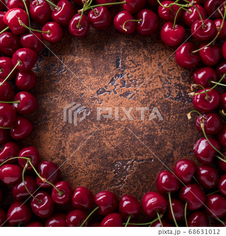 Sweet organic cherries on old copper table. 68631012