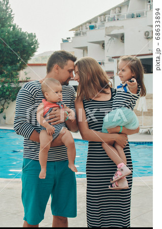 Ramile with children walks by the pool. Holidays in hot countries. the territory of the hotel 68633894