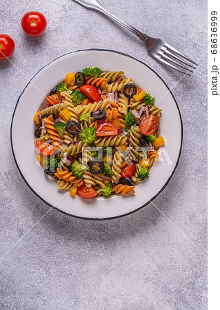 Pasta salad with tomato, broccoli, black olives. Pasta salad with tomato, broccoli, black olives. 68636999