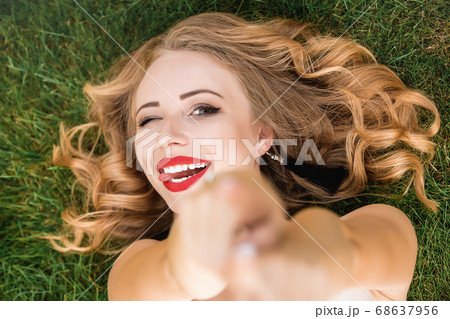 Caucasian pretty woman with curly black hair lying 68637956