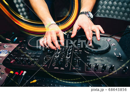 music remote for information and mixing music in nightclub with DJ hands closeup music remote for information and mixing music in nightclub with DJ hands closeup 68643856