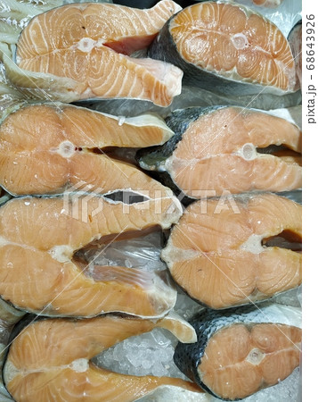 One slice of fish on ice, red fish - salmon in a market. 68643926