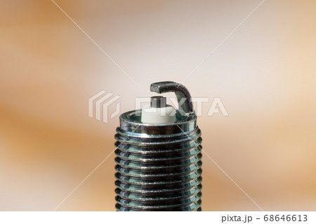 Auto service. New spark plug as spare part of car. Auto service. New spark plug as spare part of car. 68646613