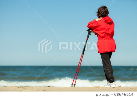 Nordic walking. Woman hiking on the beach. Nordic walking. Woman hiking on the beach. 68646614