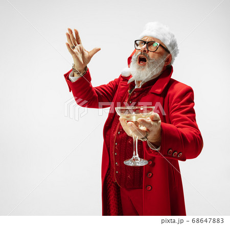 Modern stylish Santa Claus in red fashionable suit isolated on white background Modern stylish Santa Claus in red fashionable suit isolated on white background 68647883