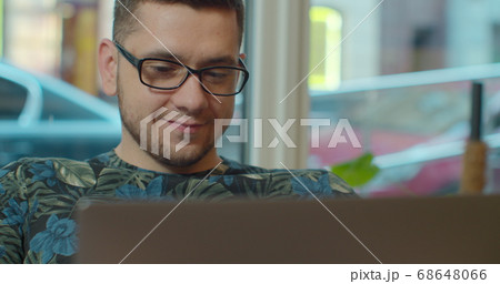Man freelancer using laptop online working in internet, guy typing on computer surfing web looking at screen enjoying distant job. 68648066
