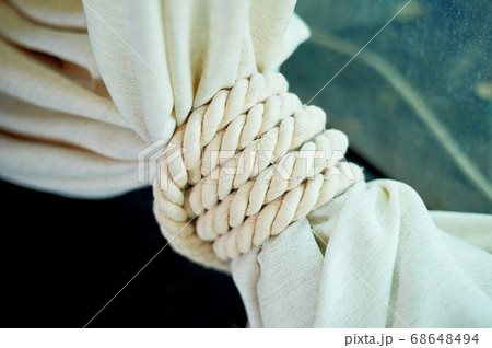 White rope, used as a decorative pick on the fabric. The sea decor of the house. 68648494