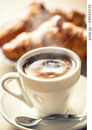Cup of coffee and fresh croissants - italian or 68649336