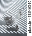 Three white plastic and glass vials in bright light 68649340