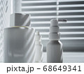 Still life with three blank white vials in sunlight on a windowsill 68649341