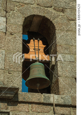 Medieval steeple made of stone bricks with bell 68649420