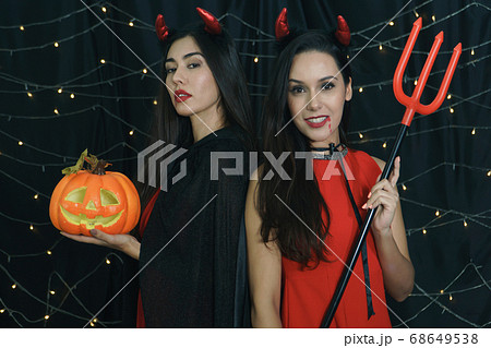 Halloween girl devil with carved pumpkin Halloween girl devil with carved pumpkin 68649538
