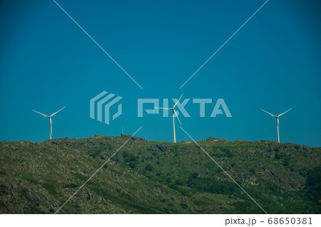 Wind turbines for electric power generation on hill 68650381