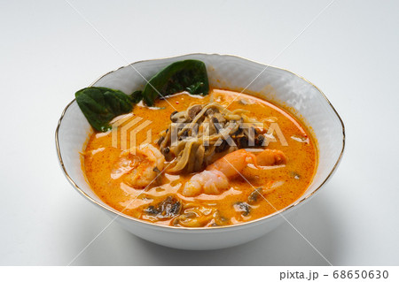 Traditional Asian soup with chicken or pig meat with udon noodles in a white bowl, isolate. 68650630