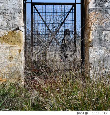 man behind vintage metal door man behind vintage metal door 68650815