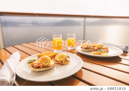 Cruise ship vacation food breakfast on suite balcony table in room service. Caribbean travel getaway, winter escape or honeymoon cruise in Europe or Santorini Cruise ship vacation food breakfast on suite balcony table in room service. Caribbean travel getaway, winter escape or honeymoon cruise in Europe or Santorini 68651810