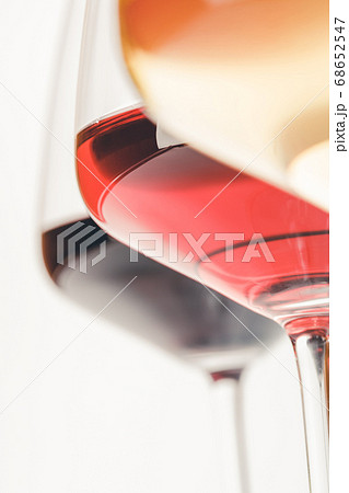 Glasses of white, red and rose wine over white background, close up 68652547