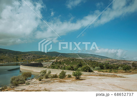 Rocky shore next to the concrete dam of Rossim Lake Rocky shore next to the concrete dam of Rossim Lake 68652737