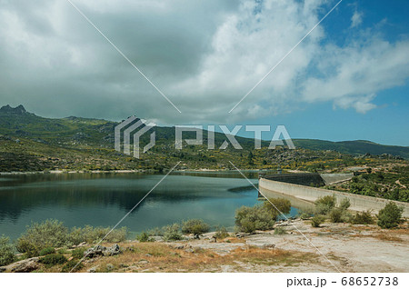Rocky shore next to the concrete dam of Rossim Lake 68652738