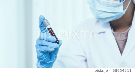 doctor's hand holding a sample blood tube for analysis and test virus disease in the laboratory 68654211