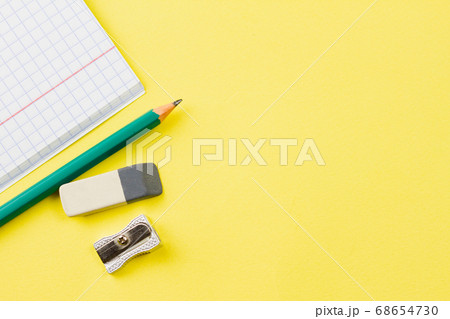 Notebook with a pencil on a yellow background. Notebook with a pencil on a yellow background. 68654730