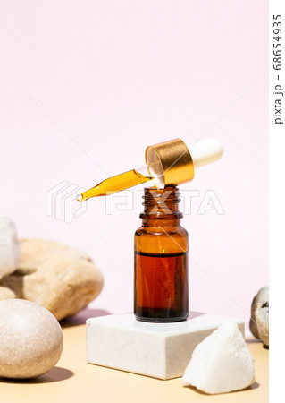 Brown bottle with cosmetic liquid. Brown bottle with cosmetic liquid. 68654935