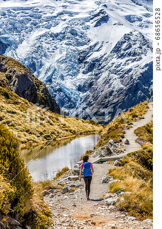 Hiking girl in New Zealand Mt Cook nature mountain. Alone hiker walking on popular trail Mueller Hut route in Mount Cook National Park mountains 68656528
