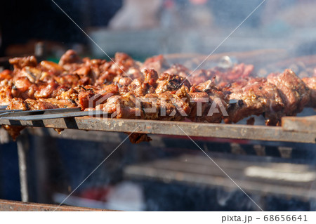 Grilled kebab cooking on metal skewer Grilled kebab cooking on metal skewer 68656641