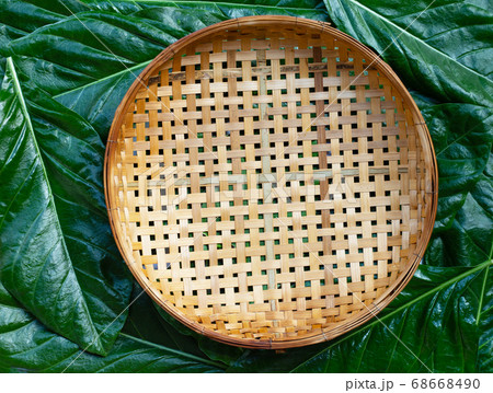 Empty wooden bamboo threshing basket on Noni  68668490