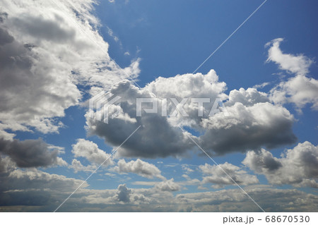 Cumulus clouds in the blue sky on a bright sunny day Cumulus clouds in the blue sky on a bright sunny day 68670530
