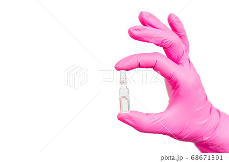 Hand of female doctor in pink glove with ampoule 68671391