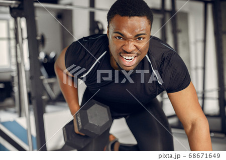 A handsome black man is engaged in a gym A handsome black man is engaged in a gym 68671649